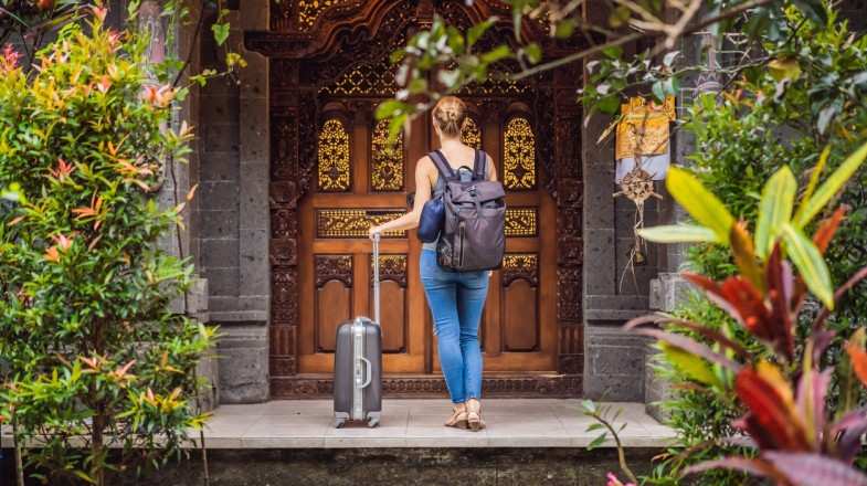 View of a female tourist checking in authentic hotel in Bali, Indonesia
