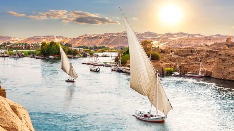 Sailboats on the Nile with the bright sun during winter in Egypt.
