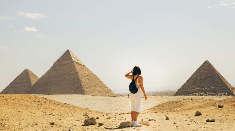 A woman exploring the Pyramids of Giza on her Cairo to Petra trip.