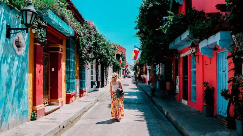 A woman strolling through the old city of Cartagena during summer in Colombia.