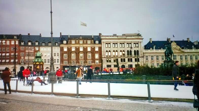 Children and adults enjoy ice skating during winter in Denmark.