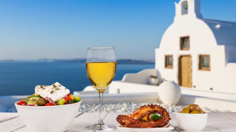 Greek food and wine with Santorini in the background
