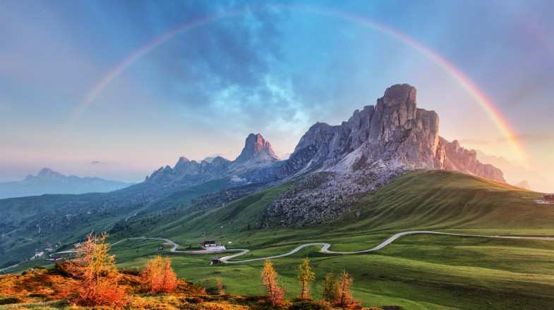 Italian Alps with a rainbow over the alpine mountains in Italy in September.