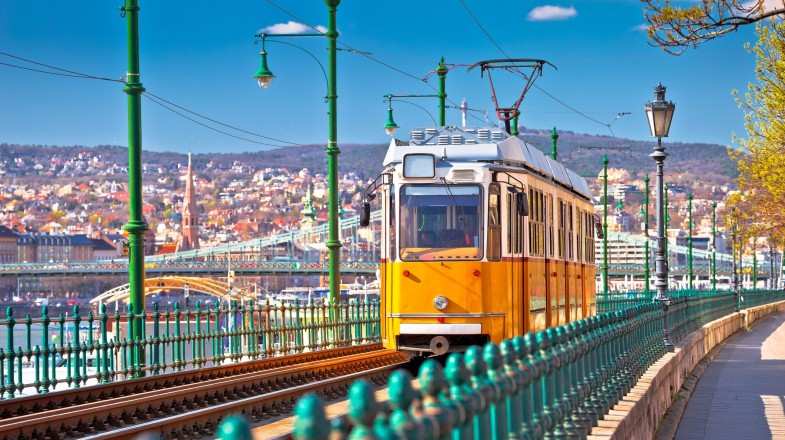 See a yellow tramway in Budapest while touring Hungary in June.