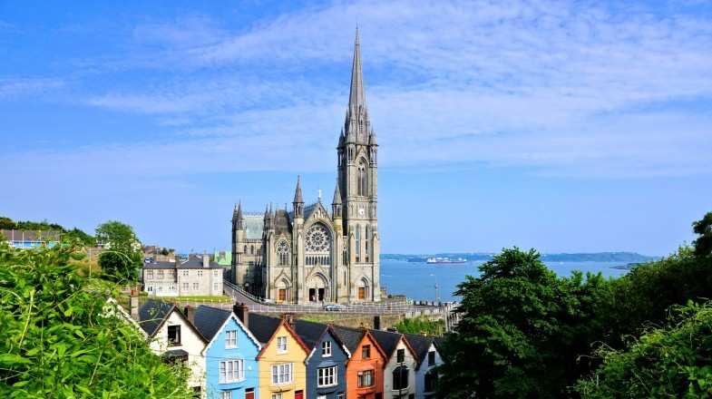 Colorful row houses with the towering cathedral in background, Cork, Ireland