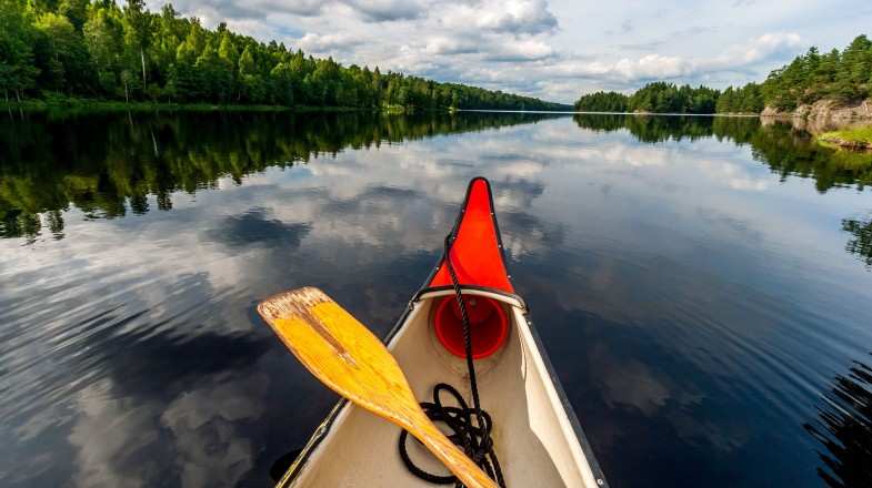 Kayak gliding on a lake in Sweden in June.