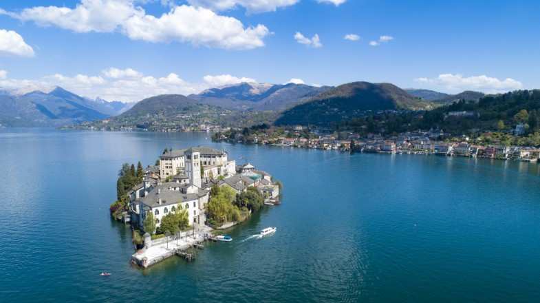 Aerial view of San Giulio Island and Lake Orta, one of the best lakes to visit in Italy.
