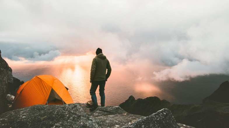 A man looking over a camp site in Norway in October