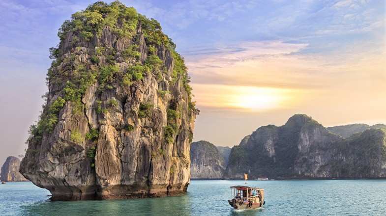 Watching the seascape sunset at Halong Bay is one of the top things to do in Vietnam