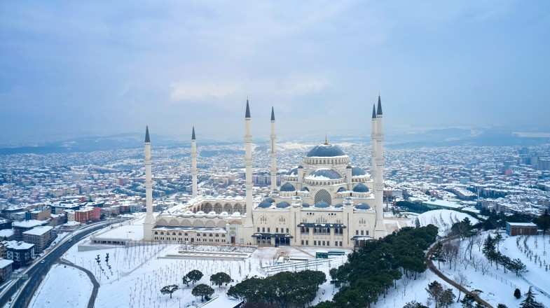 A view of Grand Mosque covered in snow during winter in Turkey.
