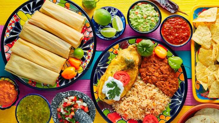 A selection of traditional Mexican foods, including tamales and arroz rojo.