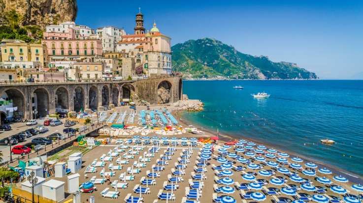 Atrani beach in Campania is beautifully nestled between the steep cliffs of Tyrrhenian sea and a must visit if you have 2 weeks in Italy.