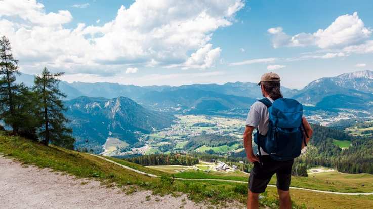 A hiker in the Bavarian Alps on a sunny day in Germany in August.