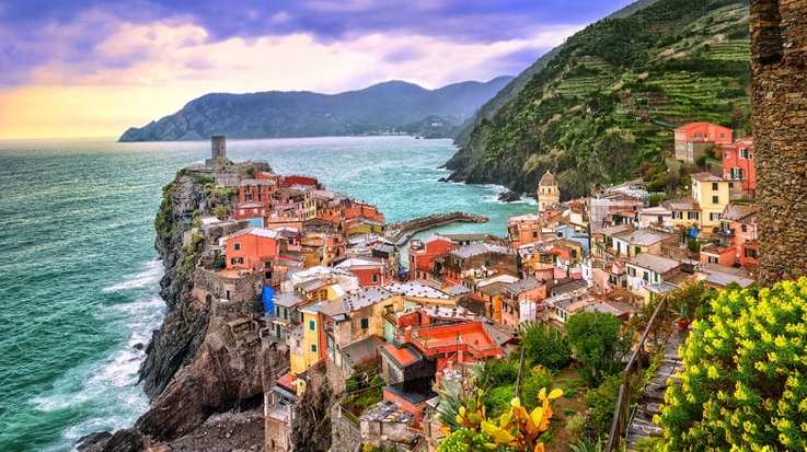The colorful village of Vernazza and ocean coast in Cinque Terre in Italy on a clear day.