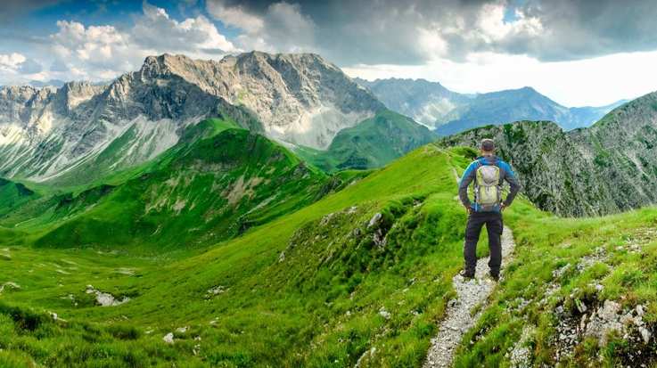 A hiker man on hiking trail at Bavaria in Germany in June.