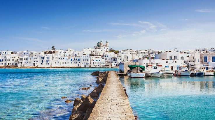 The picturesque white houses of Greece against the blue waters and sky
