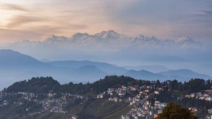 Kanchenjunga range peak after sunset with Darjeeling town in the foreground in India in January.