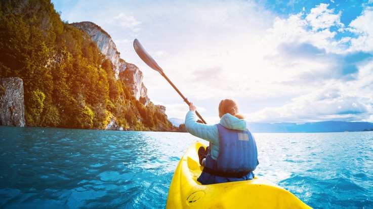 A woman paddles kayak on the lake in Patagonia in October.