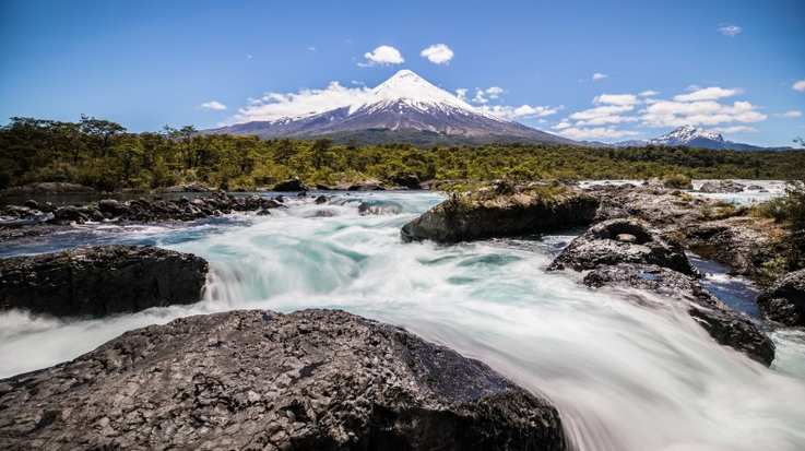 Waterfall in the foreground of the Osorno Volcano within the Lake District in Chile in March.