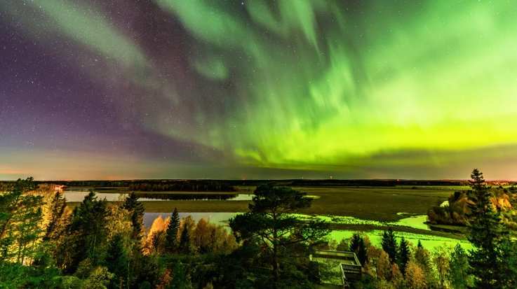 Green lights in the night sky known as northern lights in Scandinavia