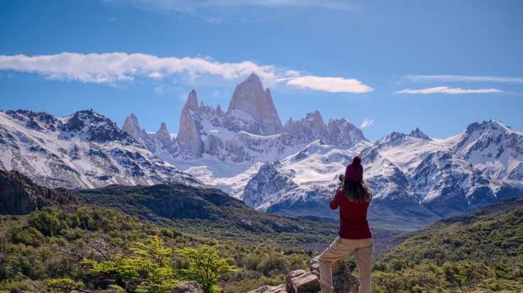 A girl tourist capturing the beauty of Mount Fitz Roy, one of the things to do in Argentina.
