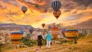 A couple watching hot-air balloons on a trip from Antalya to Cappadocia.