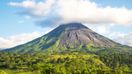 A view of Arenal Volcano in Costa Rica, an active volcano popular for many things to do in Costa Rica like hiking, hot springs and mud baths.