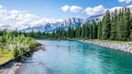 A river in Canmore Alberta with the Rockies in the background in Canada in August.