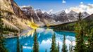 A landscape view of Moraine Lake with mountains in Canada in July.