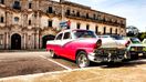 Old vintage cars parked outside in Old Havana in Cuba in February.