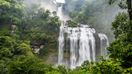 Waterfall on a cliff in the tropical rainforest in the Bolaven Plateau