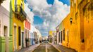Colorful houses line up on stone paved streets