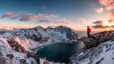 A man hikes the Ryten Mountain, one of the best things to do in Norway.