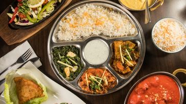 An assortment of traditional Indian food served on an Indian thali.