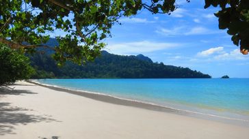 Empty beach with crystal clear water in Langkawi in Malaysia in October.