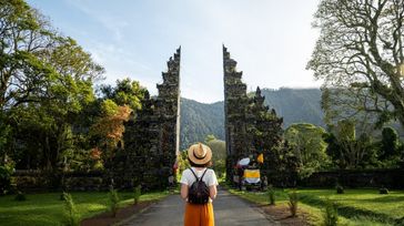 Women tourist travelers explore the Balinese temple, which is one of the top things to do in Indonesia.