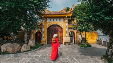 Woman explores Tran Quoc Pagoda before traveling from Hanoi to Ho Chi Minh.