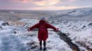 Female traveler on a sunrise hike in Iceland