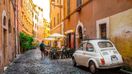 A narrow street in Trastevere, Italy with a lovely Italian restaurant.