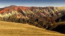 The mountains of Quebrada de Humahuaca flaunt waves of colors, ranging from rich bands of red, vibrant pink, creamy white, and patches of green.