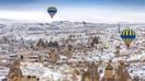 Early morning in Cappadocia, with hot air balloons in the sky.