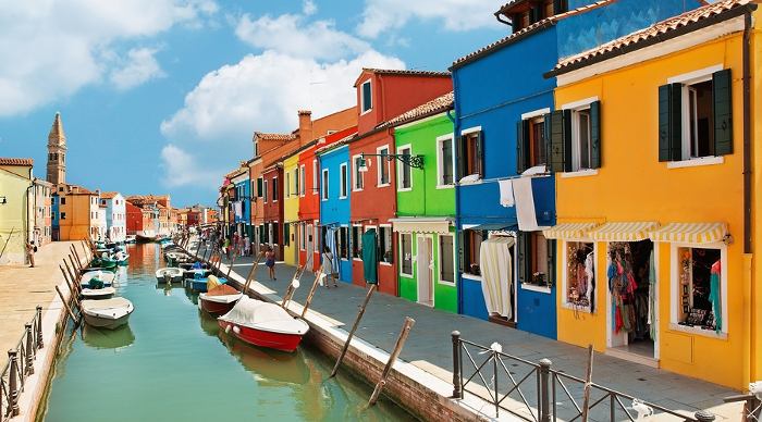 Burano island canal, colorful houses and boats, Italy.