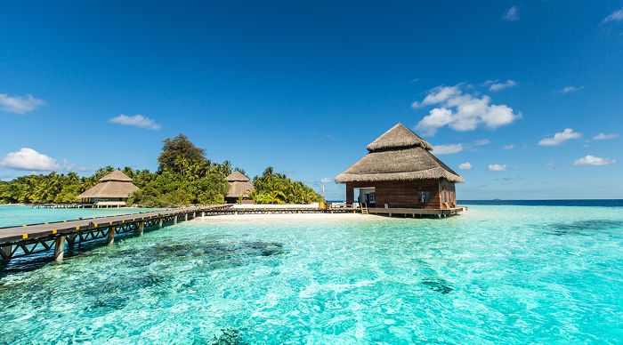 Small Maldives tropical island with beach villas 