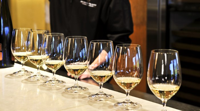 Row of white wine glasses in wine tasting event