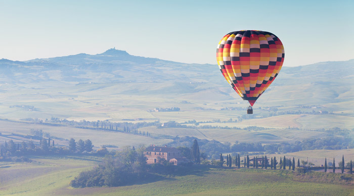 big balloon flies over Tuscany