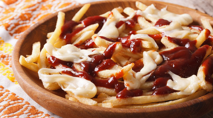 Traditional Canadian fast food poutine with sauce and cheese 