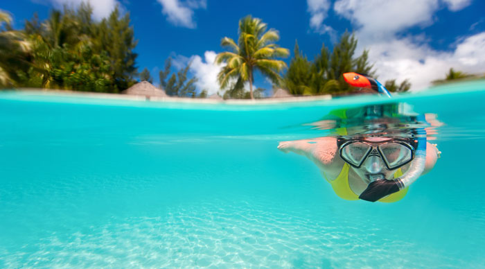 Woman snorkeling in clear tropical waters