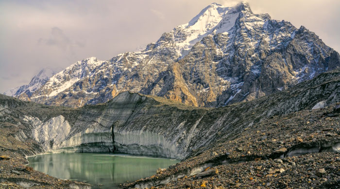 Lake on Engilchek glacier under peaks of scenic Tian Shan mountain range in Kyrgyzstan