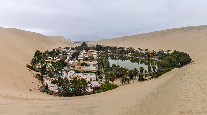 The oasis between the dunes of Huacachina in the coastal desert of Peru