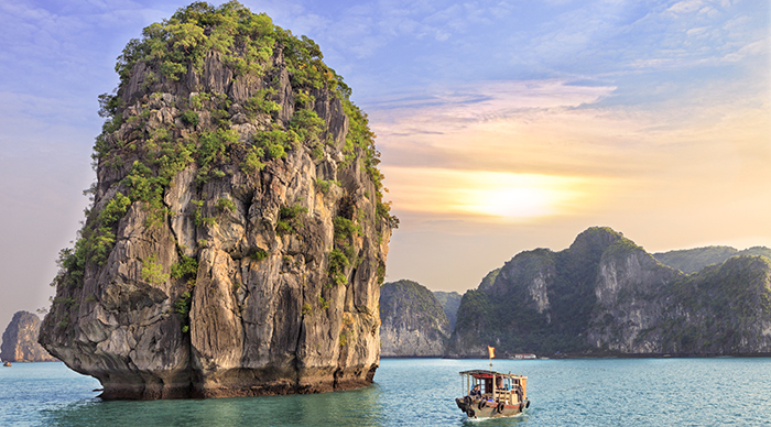 Dreamy sunset among the rocks of Halong Bay, Vietnam